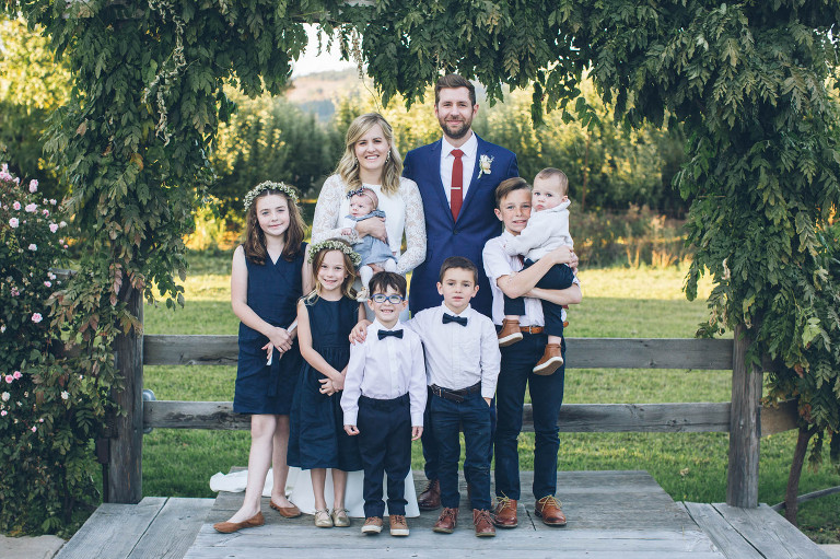 bride and groom with nieces and nephews on wedding day ring bearer and flower girls