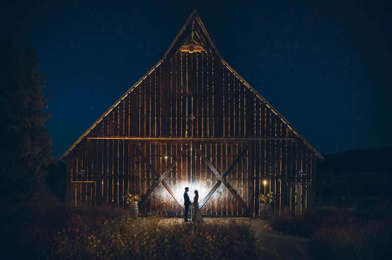 nighttime with stars and bride and groom at tin roof barn wedding venue
