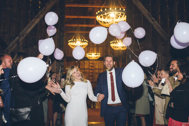grand exit with bride and groom at wedding at tin roof barn balloons
