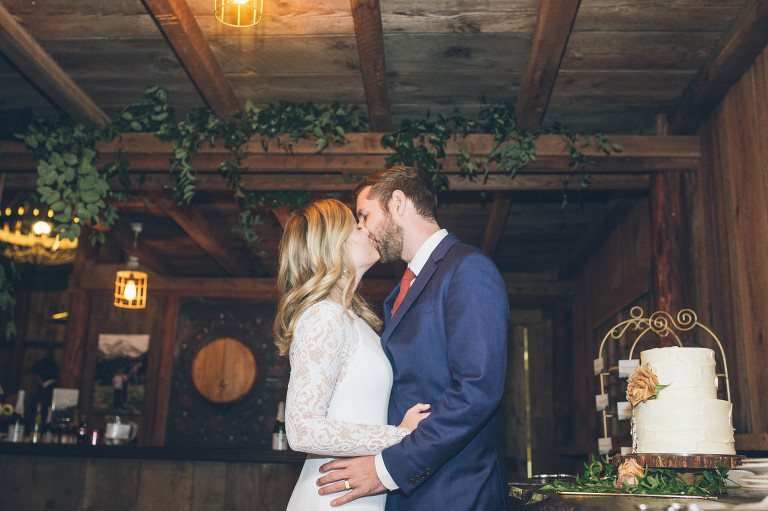 bride and groom kissing at reception at tin roof barn in washington gorge