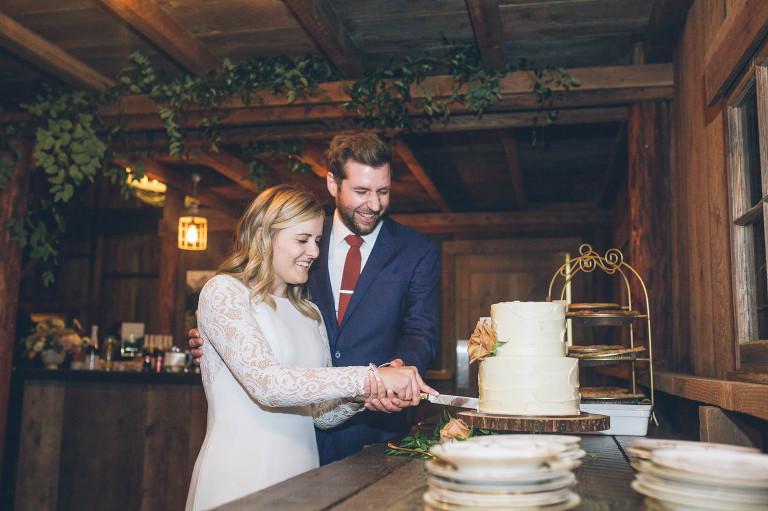 cake cut at wedding tin roof barn